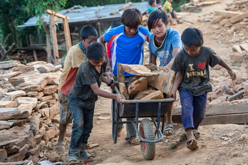 Village Kids Helping Carry Bricks