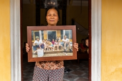 Woman Holding Family Photo