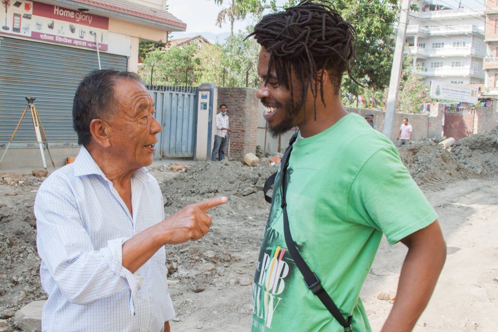 nepalese man talking to black man