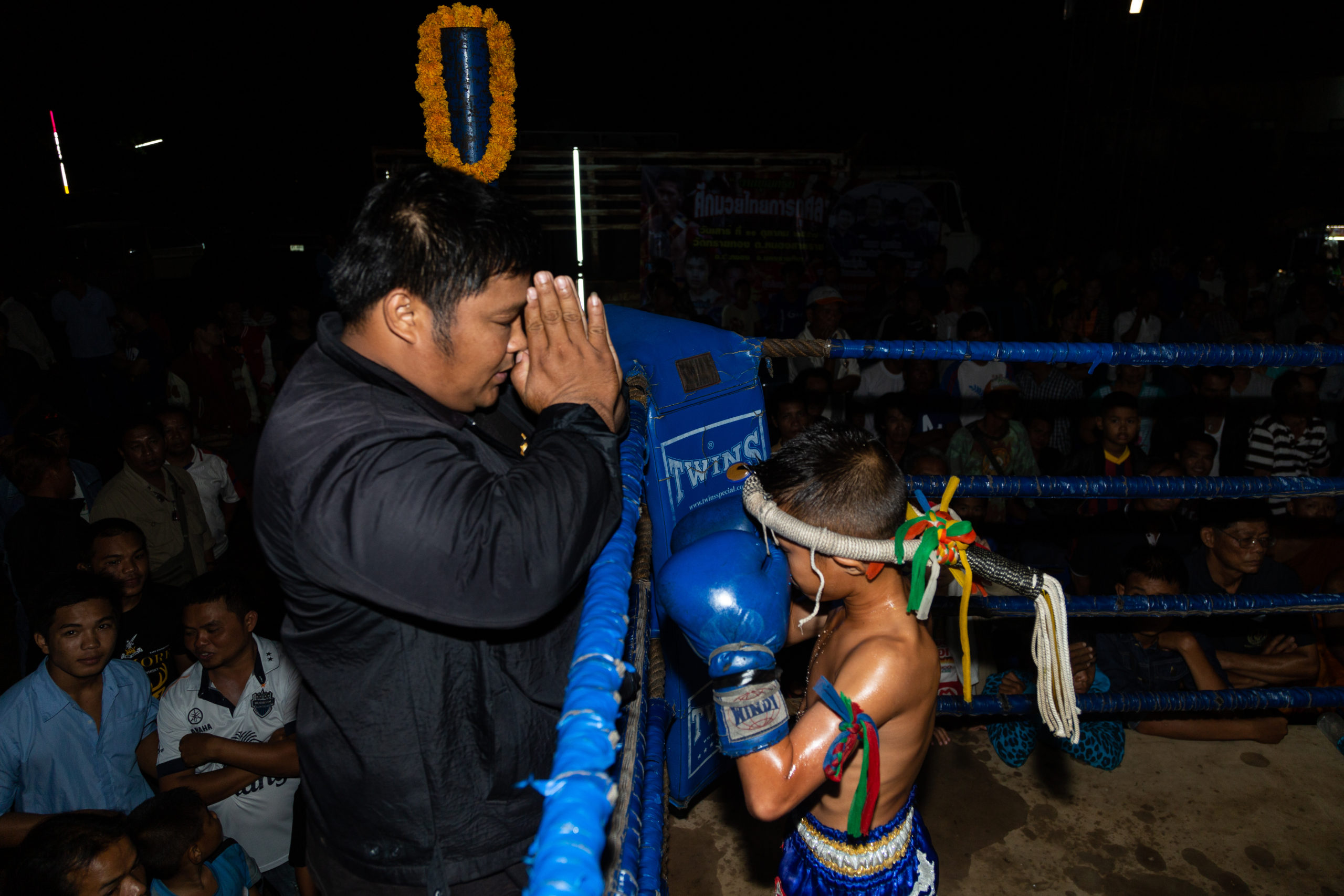 child fighter praying with coach